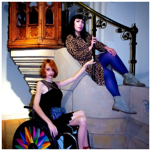Clare McNulty is draped on a chruch stairway whilst Natalie Amber hold onto the bannister from her wheelchair