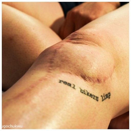 Close up of a knee with a scar on it, as well of a tattoo that reads 'real bikers limp'