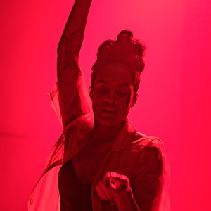 Alexandrina Hemsley dances amidst a room filled with red light