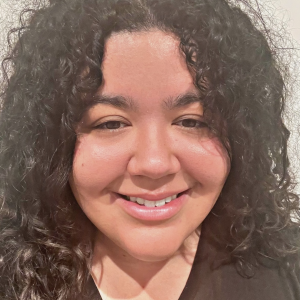 A mixed race young person with dark curly hair