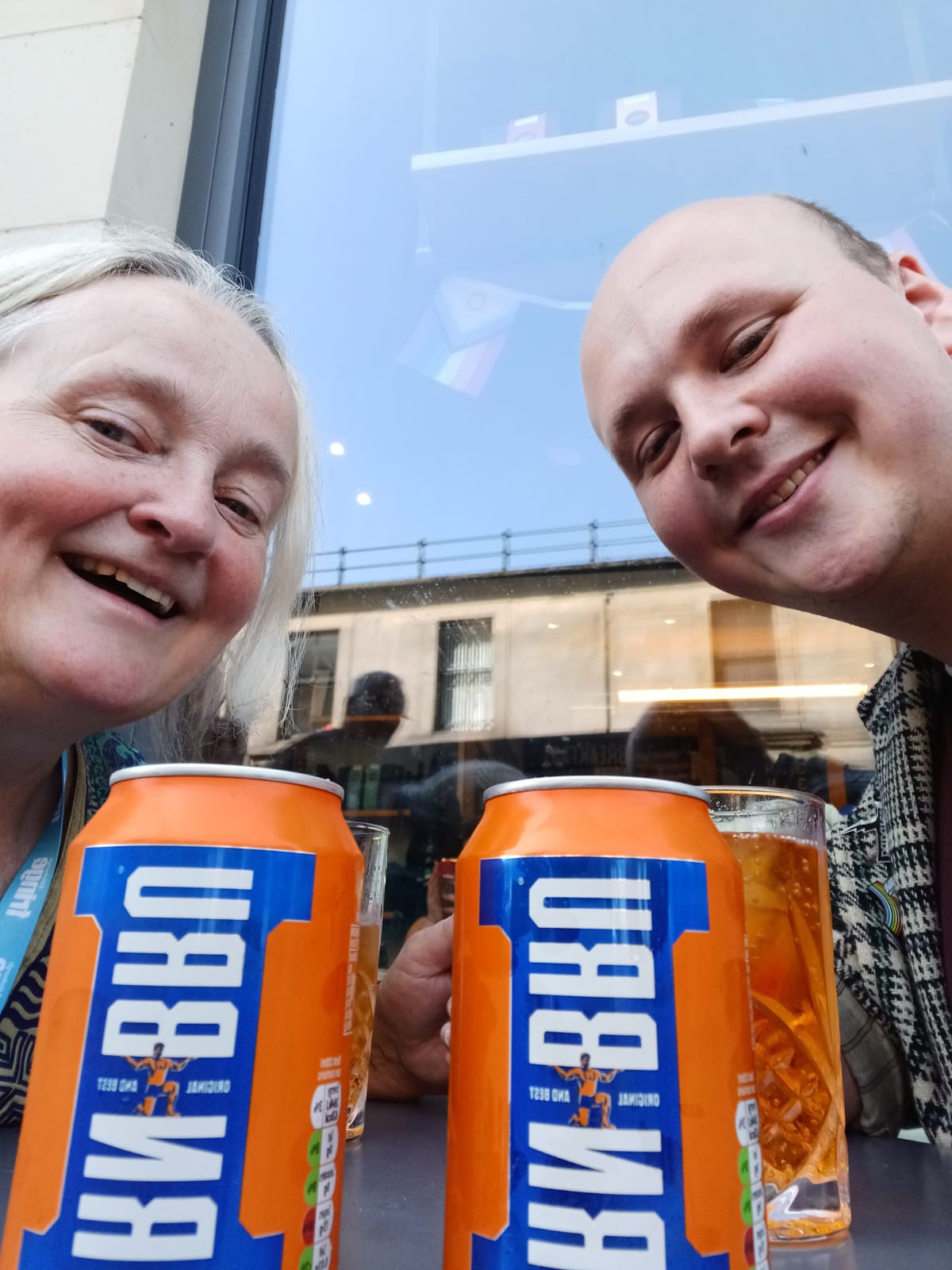 Denise and Ed hold cans of Iron Bru