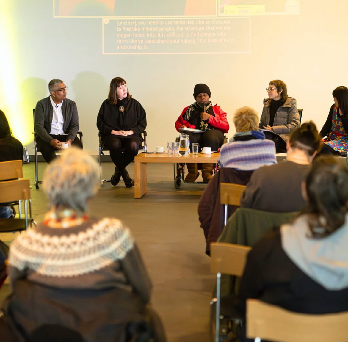 A picture of the annual Rushton Lecture, featuring a panel of speakers and some audience members