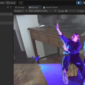 Screenshot from editing software displaying footage of a table onto which augmented reality versions of two performer are projected