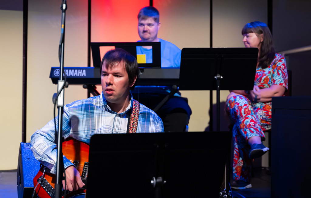 Ensemble performers pictured Johanna Jacob (Voice) Green top, Michael Brennan (guitar) in a blue and wuite checked shirt, Matthew Nealis (Keyboard)