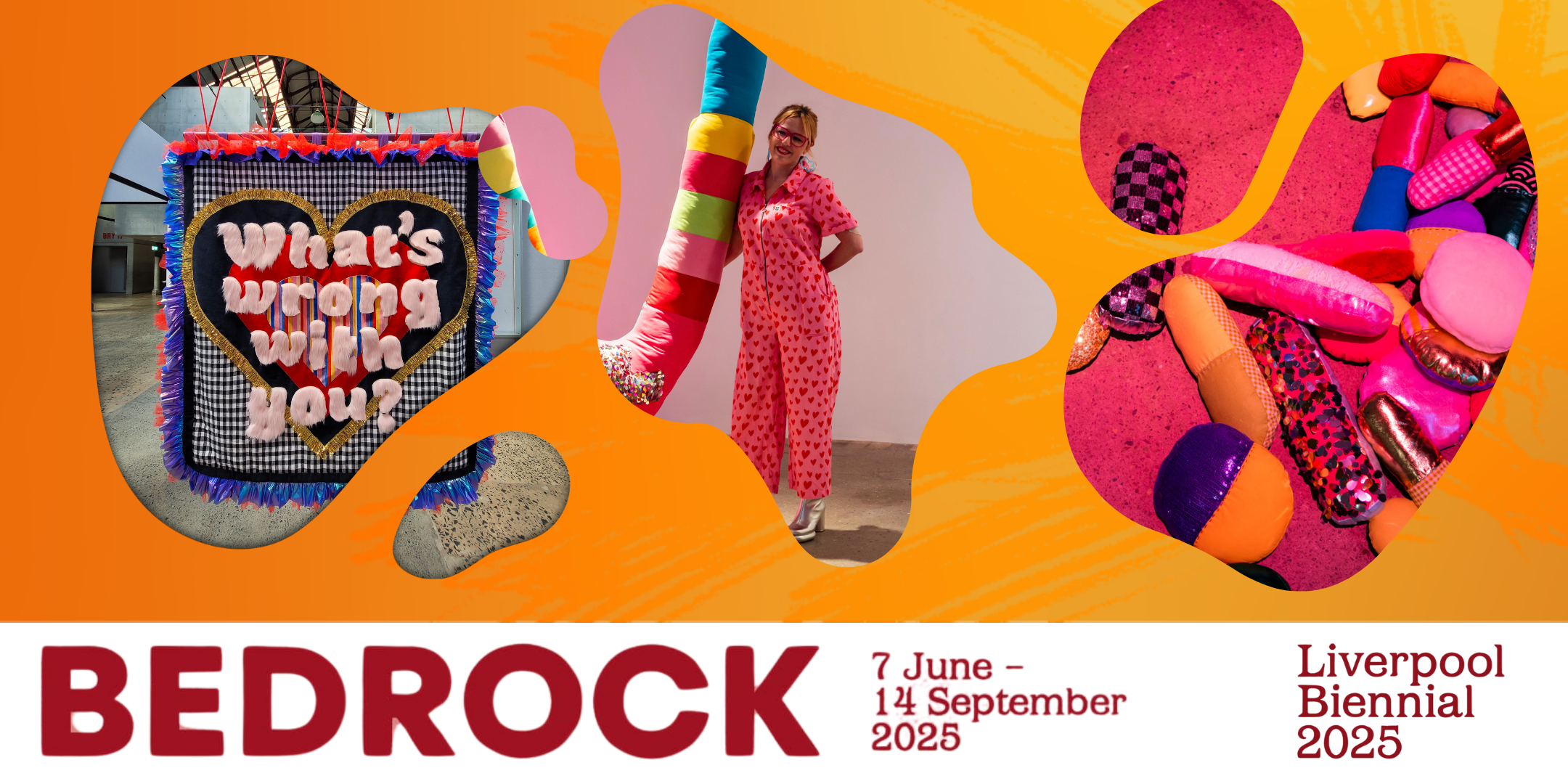 Amy Claire Mills wears glasses and stands dressed in a pink jumpsuit next to a large colourful U shaped artwork covered in fabric