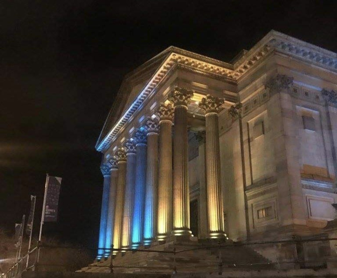 Image of Liverpool Town Hall at night lit up yellow and blue