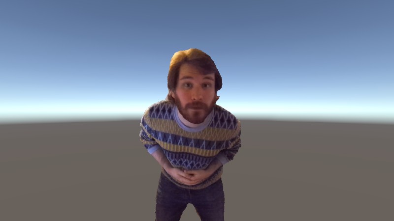 A bearded person leans forward in a virtual space 