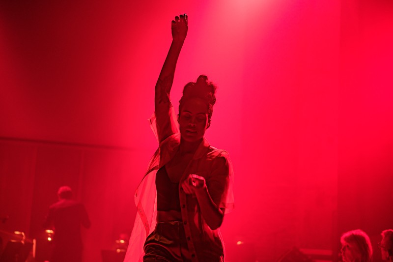 Alexandrina Hemsley in silhouette against a red coloured background