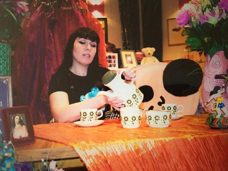 Clare McNulty pours tea from a teapot 