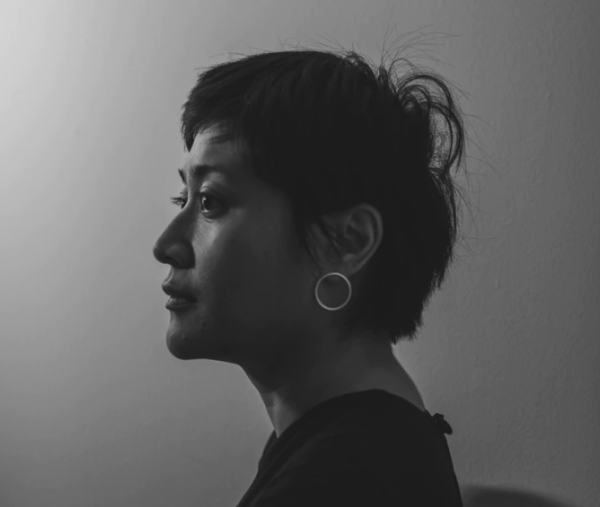 Black and white photo of an Indonesian artist with short black hair