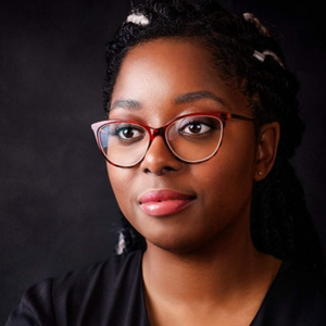 rHeadshot of a black woman wearing glasses