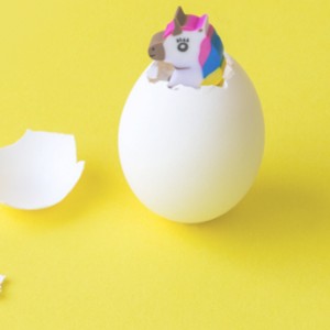 A toy unicorn emerging from an egg