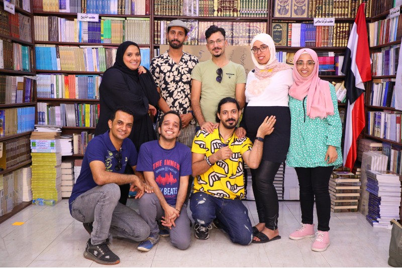 Artist Amina Atiq in a library with a group of people