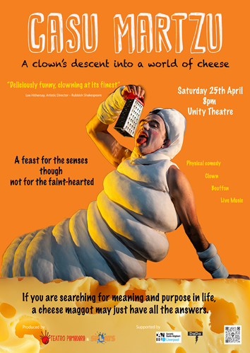 A man dressed as a maggot is lying on a bed of cheese pretending to lick a cheese grater.